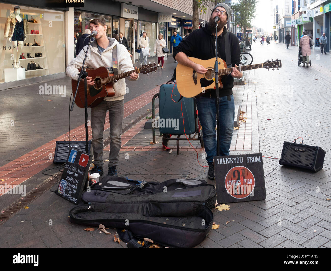 Two men street musicians called 21 Stories High singing and playing guitar  in Middlesbrough town centre Stock Photo