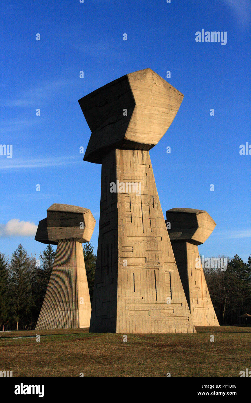 Three concrete obelisks, small, medium, and large, represent the fists of man, woman, and child killed at Bubanj during WWII, Nis, Serbia Stock Photo