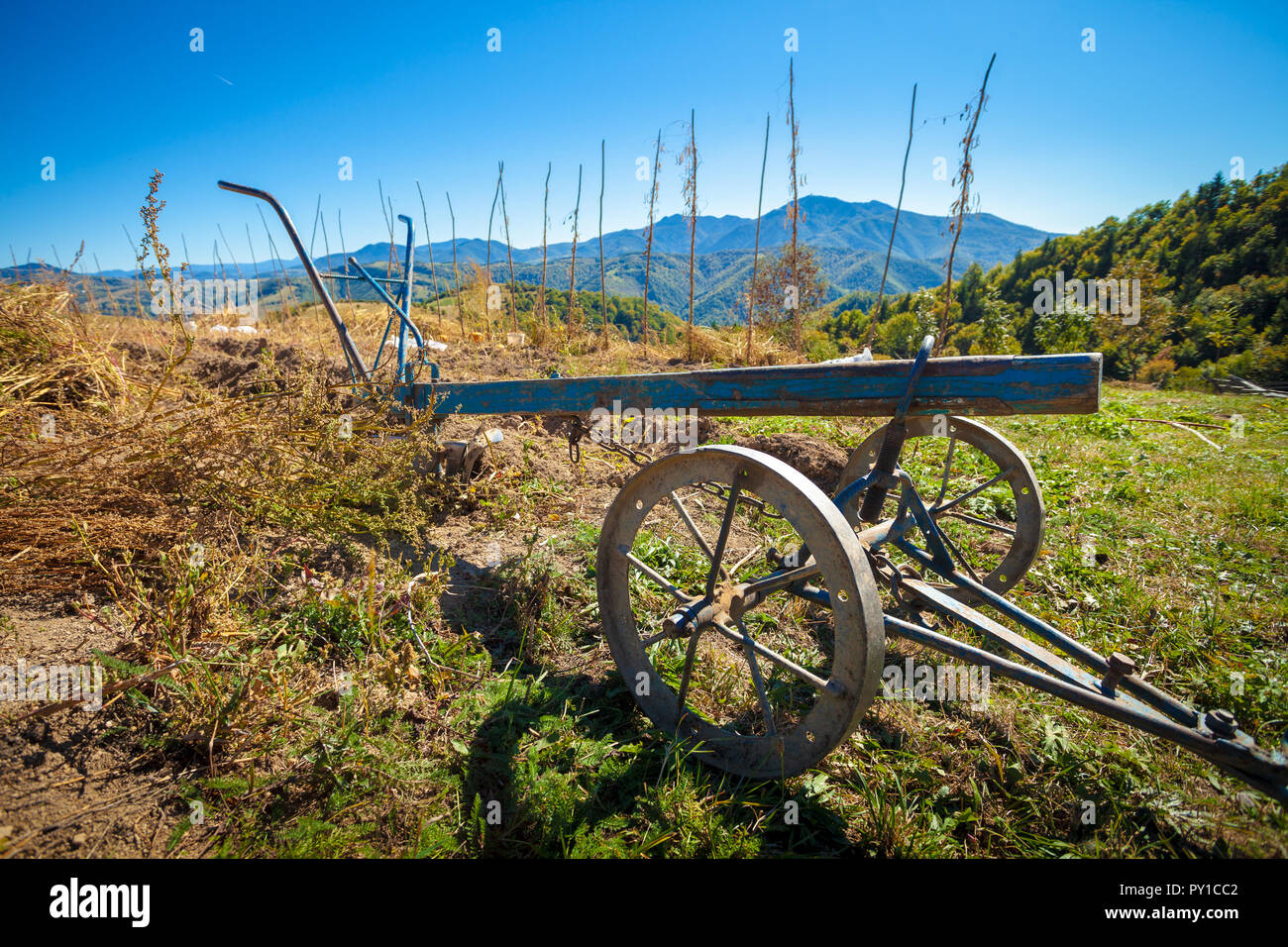 Old plow in mountain area Stock Photo