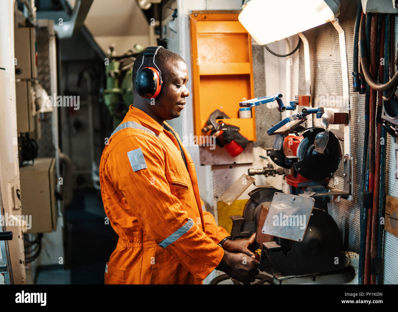 Marine engineer officer working in engine room Stock Photo Alamy