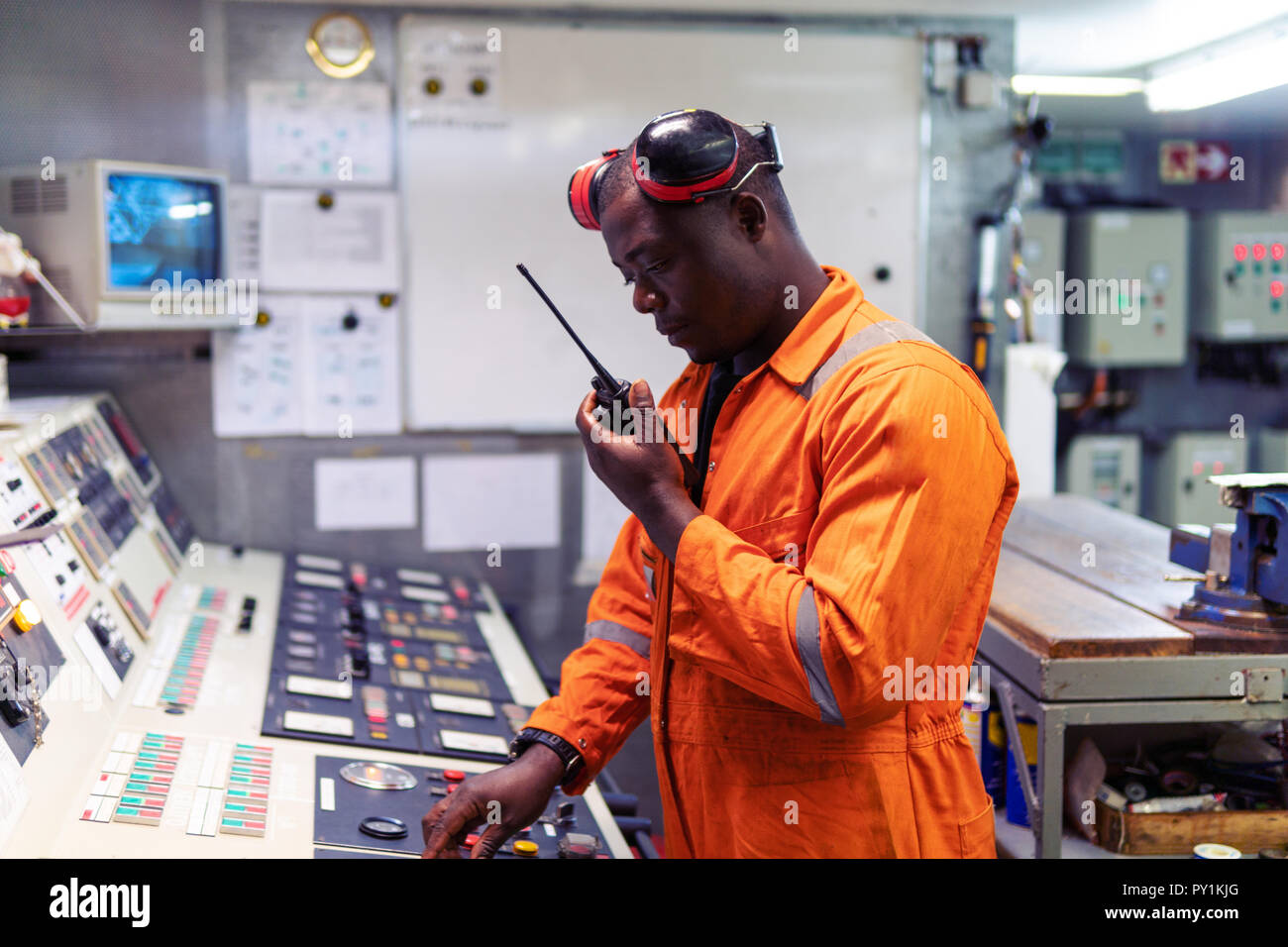 Marine engineer officer working in engine room Stock Photo Alamy