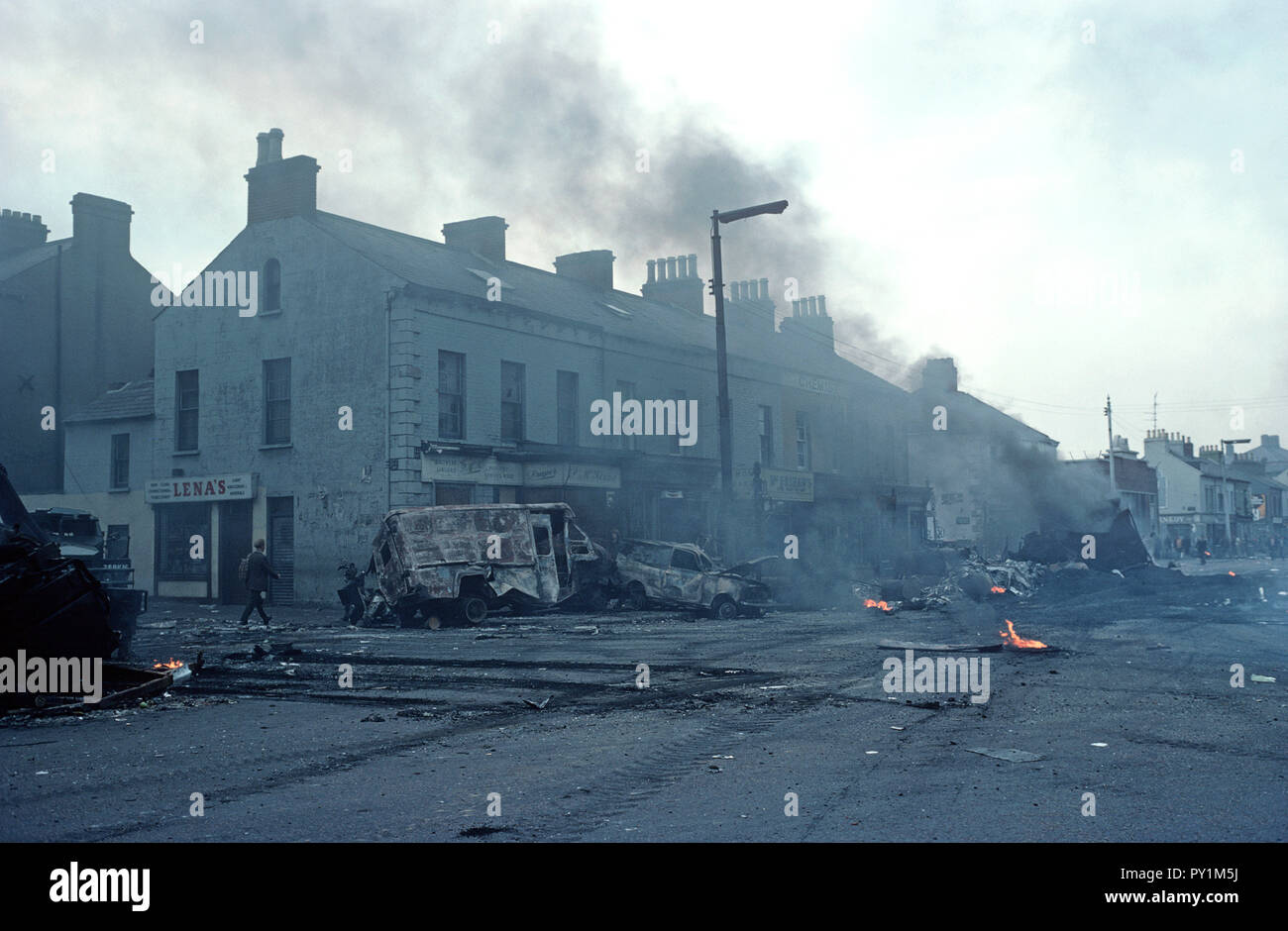 Belfast, 1976: aftermath of a night of rioting and burning vehicles in the Falls Road, West Belfast a predominately Nationalist area, during The Troubles, Northern Ireland Conflict Stock Photo