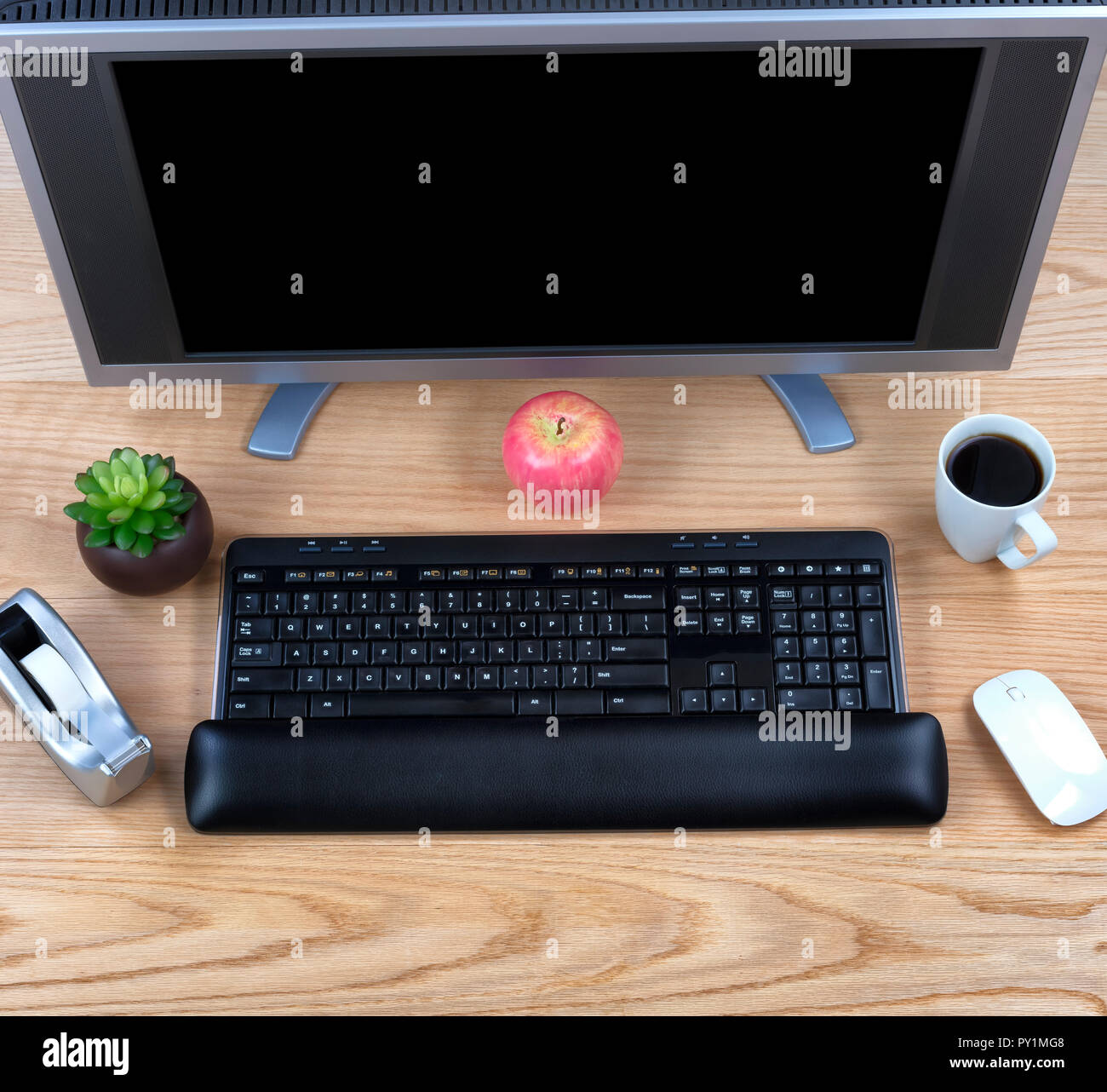 Overhead view of office technology on wooden red oak desktop Stock ...