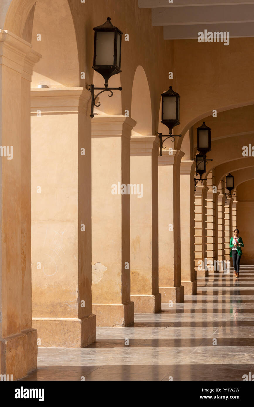 SAN CRISTOBAL DE LAS CASAS, MEXICO - MAY 25, 2018: Unidentified person walking under the archway of Museo de San Cristóbal MUSAC - Palacio de Gobierno Stock Photo