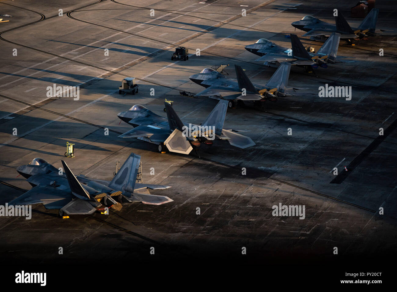 F-22 Raptors are parked near the runway at Tyndall Air Force Base ...