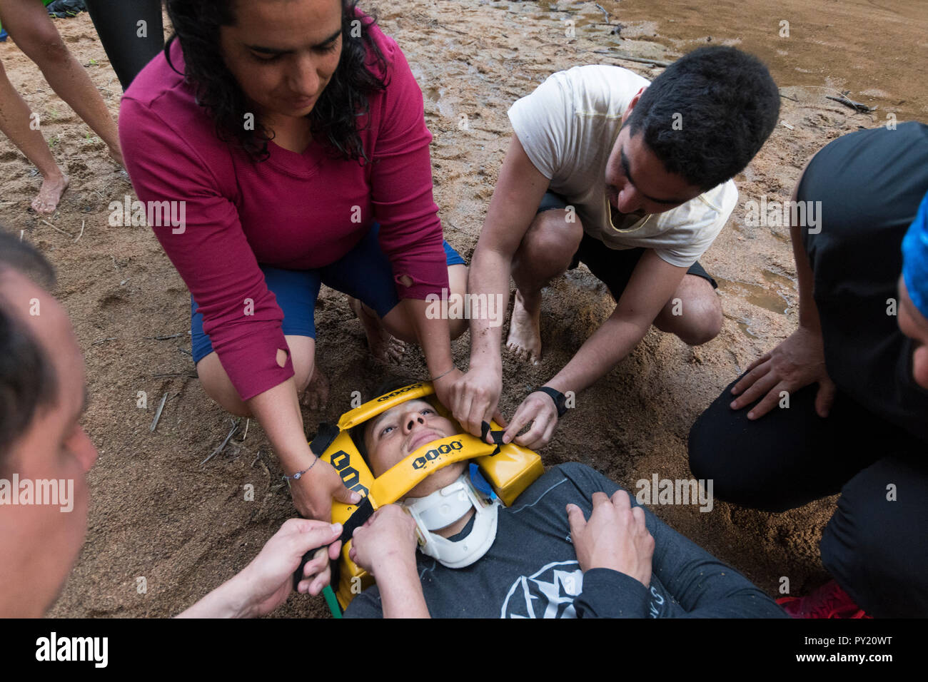 Head immobilizer being secured during a backboard evacuation drill in a wilderness first responder WFR course, El Aguacero waterfall, Chiapas, Mexico Stock Photo