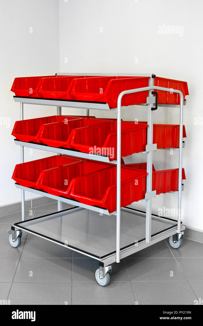 Inventory trolley with plastic red boxes for warehouse Stock Photo - Alamy