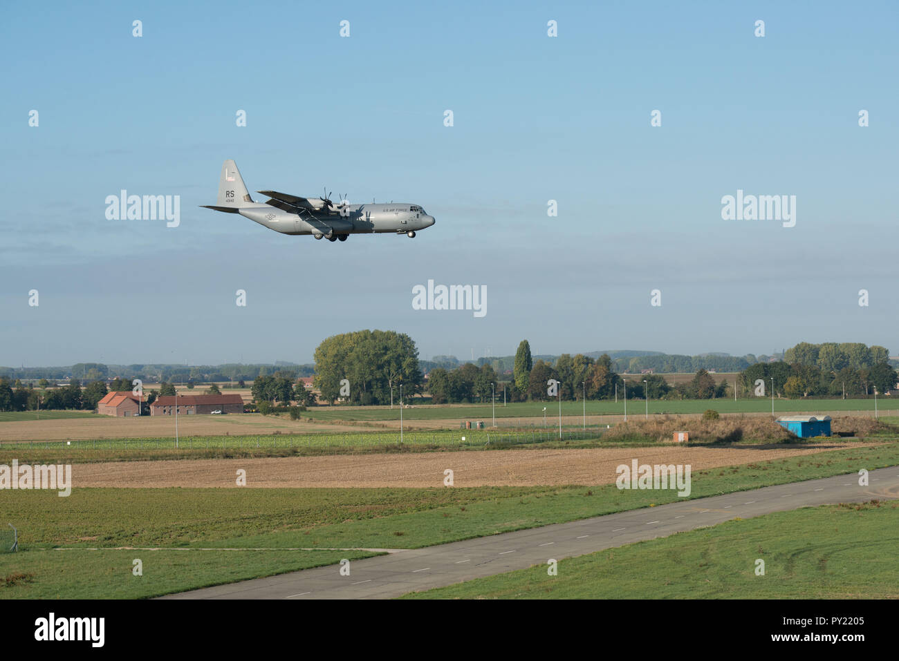 A C-130J Super Hercules of the 86th Airlift Wing, descends on Landing Zone Charlie, on SHAPE Air Field on Chièvres Air Base, Belgium, Oct. 4, 2018. The jump's goal was to validate the use of Chièvres Drop Zone to allow more NATO missions on the airfield. (U.S. Army photo by Visual Information Specialist Pierre-Etienne Courtejoie) Stock Photo