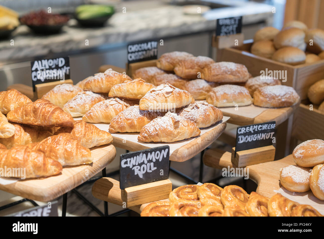 A variety of fresh croissant homemade in luxury hotel breakfast buffet, restaurant interior. Stock Photo