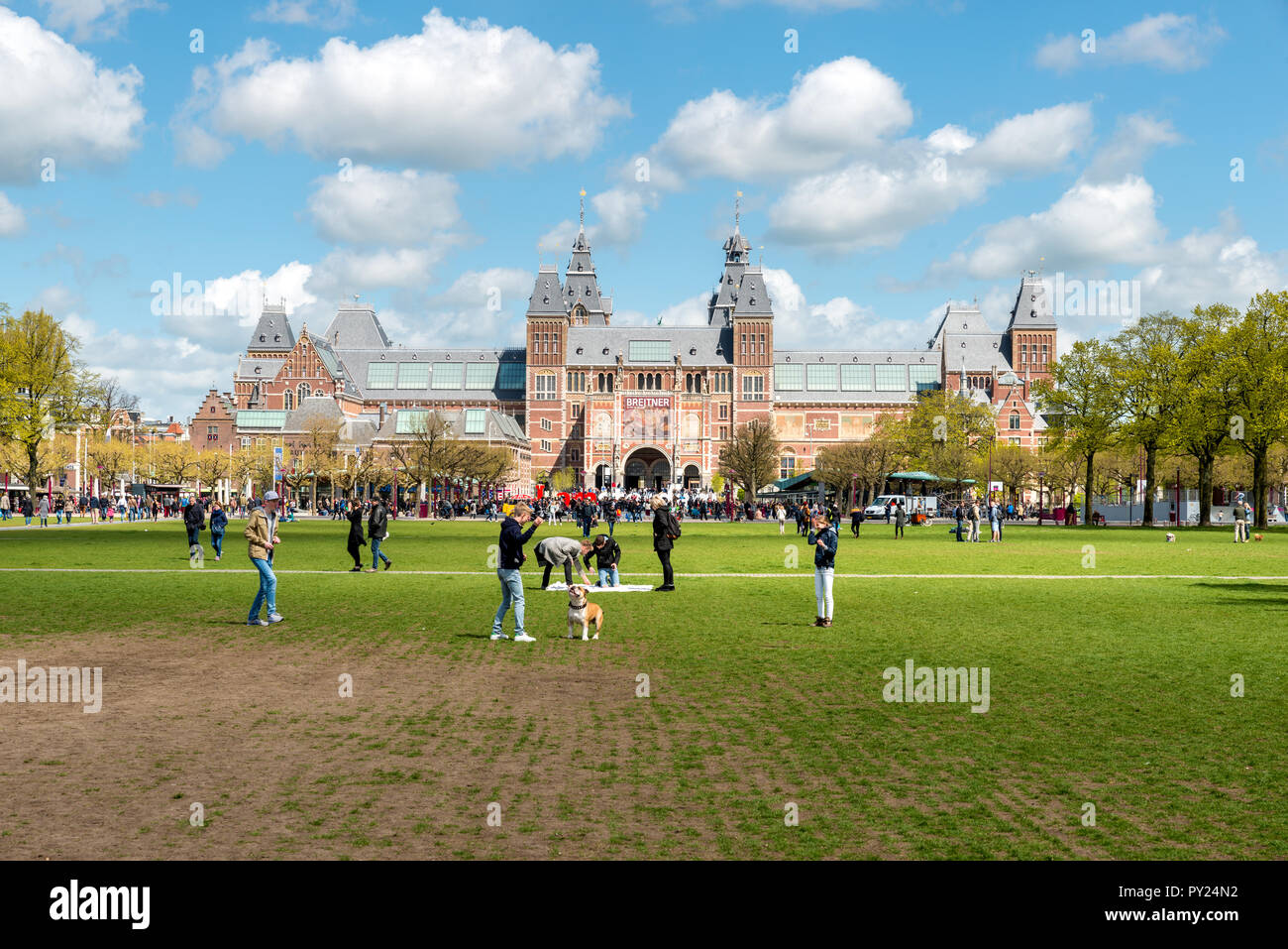 Amsterdam, Netherlands on May 03, 2016 : People chilling in the park on The Museumplein near Rijksmuseum museum area in Amsterdam, Netherlands. Stock Photo