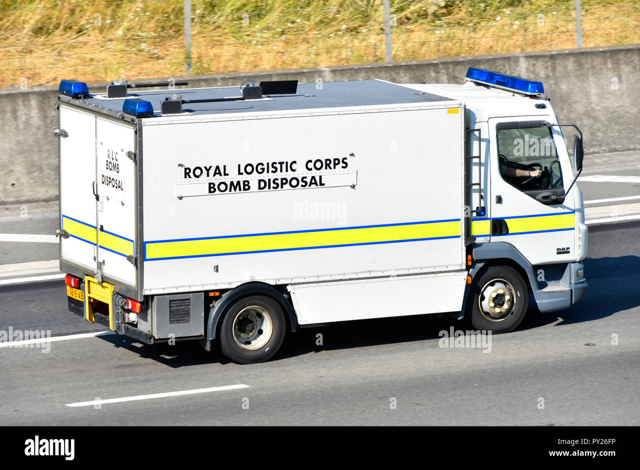 Side view British army military Royal Logistic Corps Bomb Disposal squad emergency support lorry truck driving along English motorway Essex England UK Stock Photo