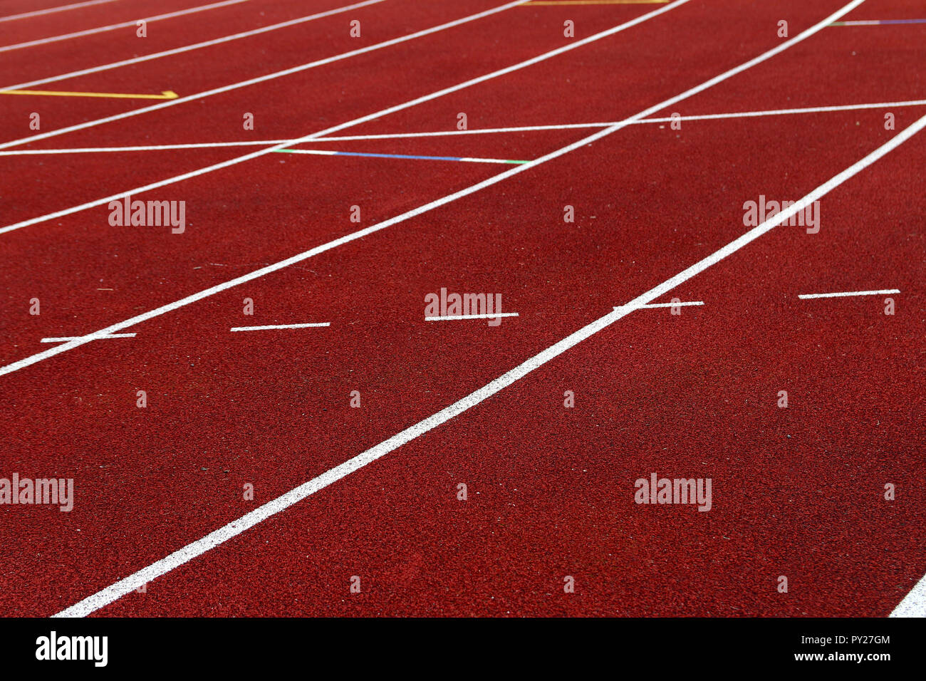 White lines to mark the lanes on an outdoor ahtletic track Stock Photo