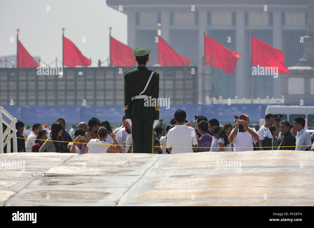 Chinese and Korean tourists and soldier in front of The Forbidden City during 60th anniversary of founding of The People's Republic Of China, Beijing. Stock Photo