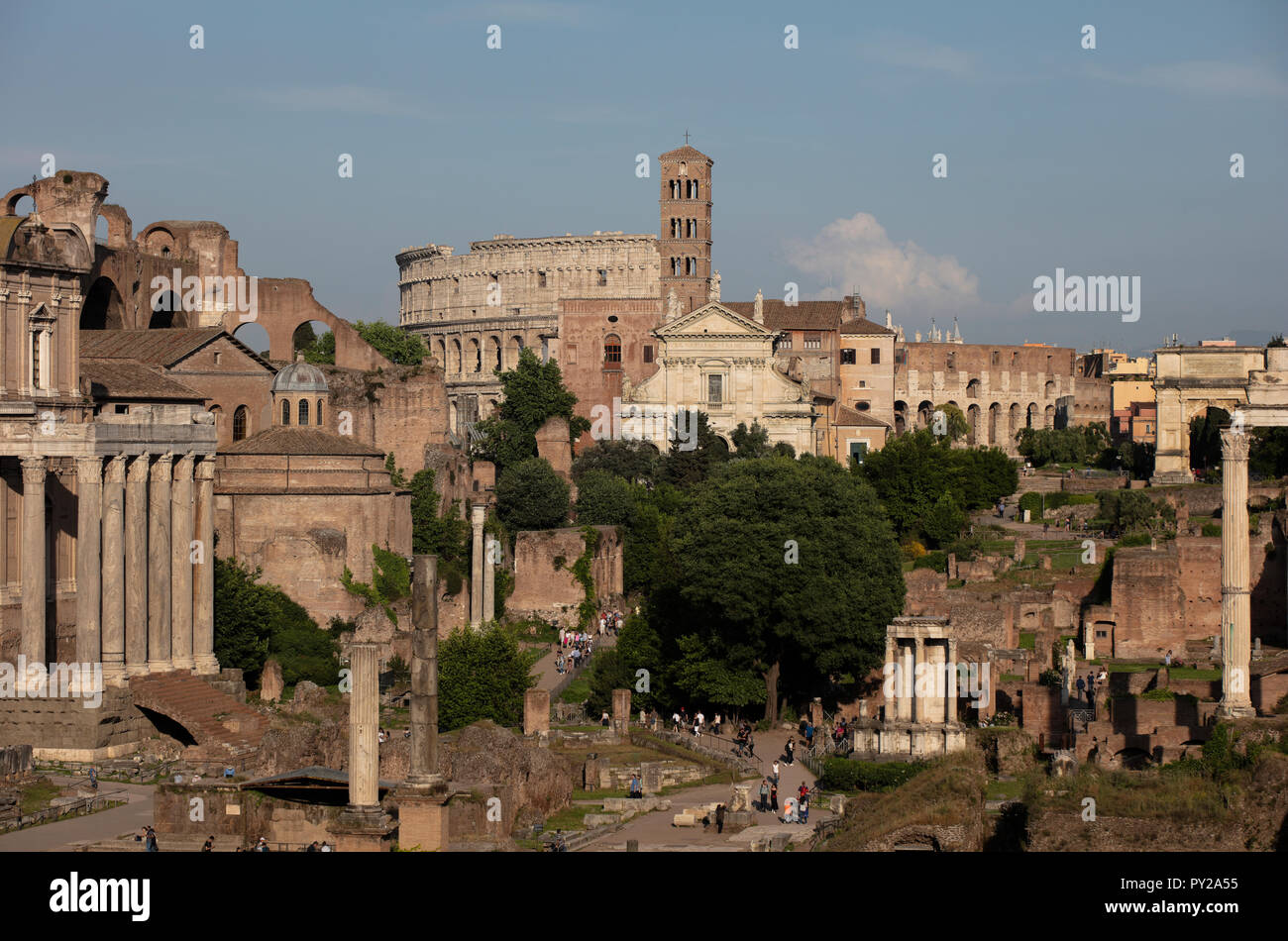 View of the Roman Forum in the evening sunlight with many of the famous ancient Roman buildings, including the Colosseum and many temples Stock Photo