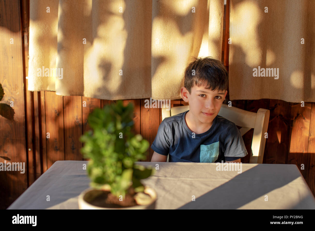 Boy sitting in a restaurant in Katouna, Lefkada, Greece Stock Photo
