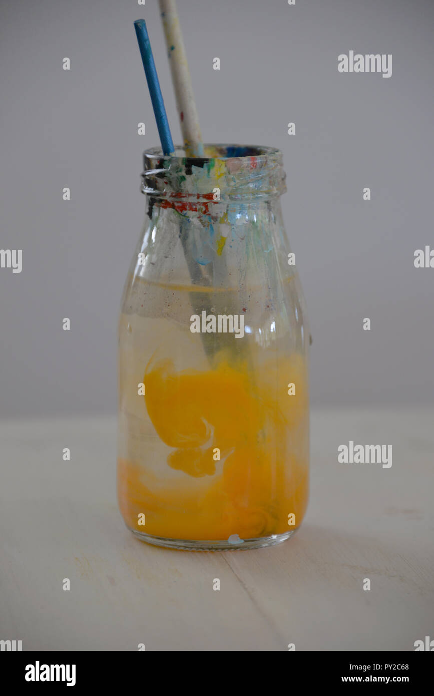 Paint brushes in a bottle of water Stock Photo Alamy