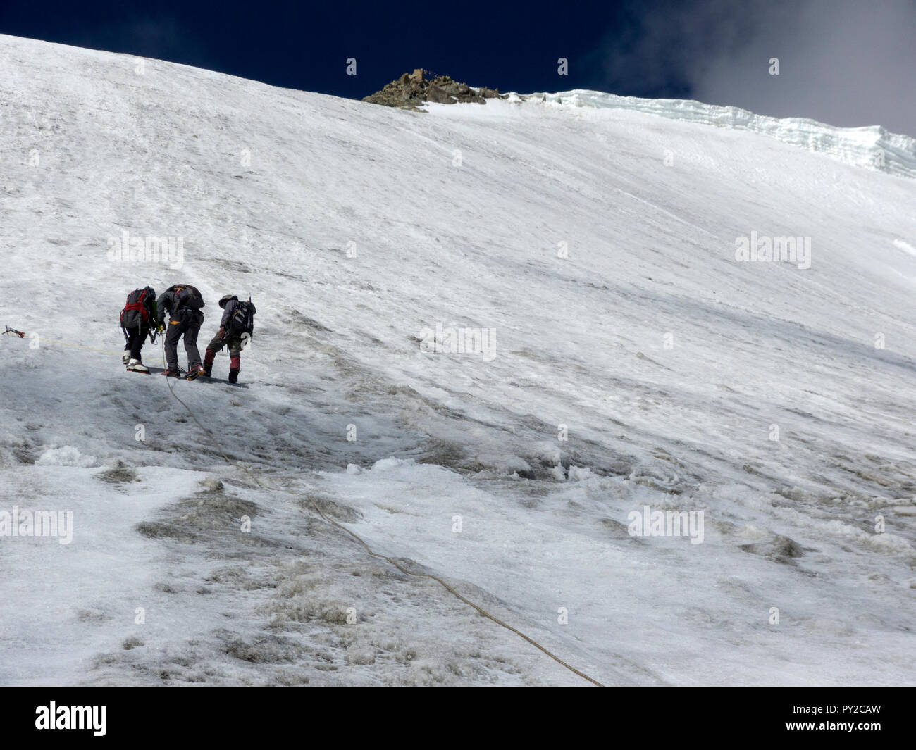 Three Sherpas opening the route on a climbing expedition to Mentok Kangri, Himalayas, India Stock Photo