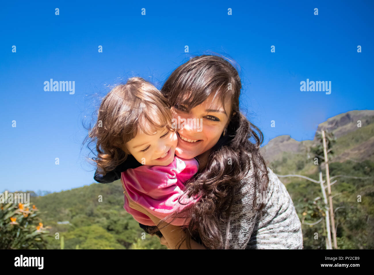 Portrait of a smiling mother hugging her daughter Stock Photo