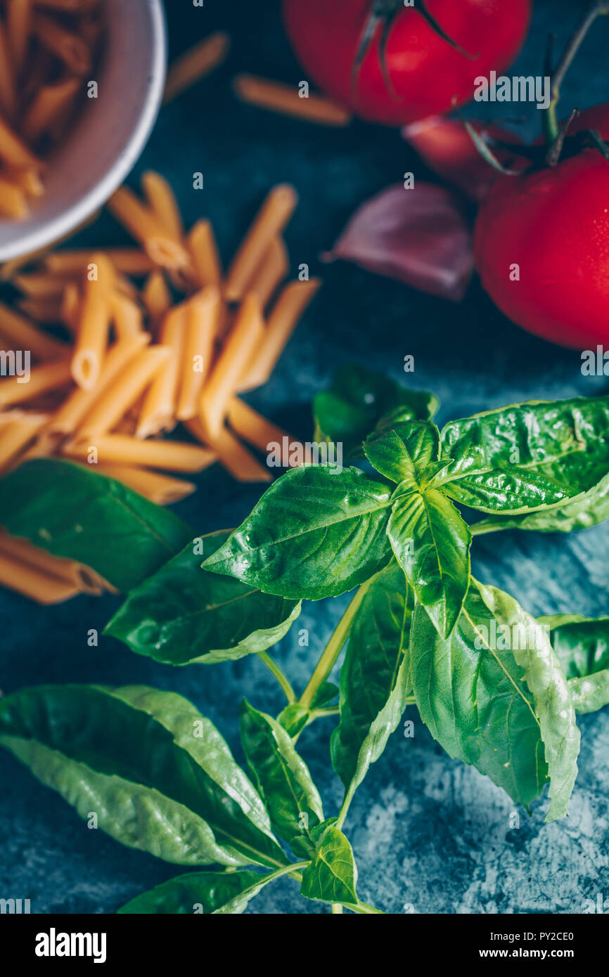 Fresh basil with penne pasta, tomato and garlic Stock Photo Alamy
