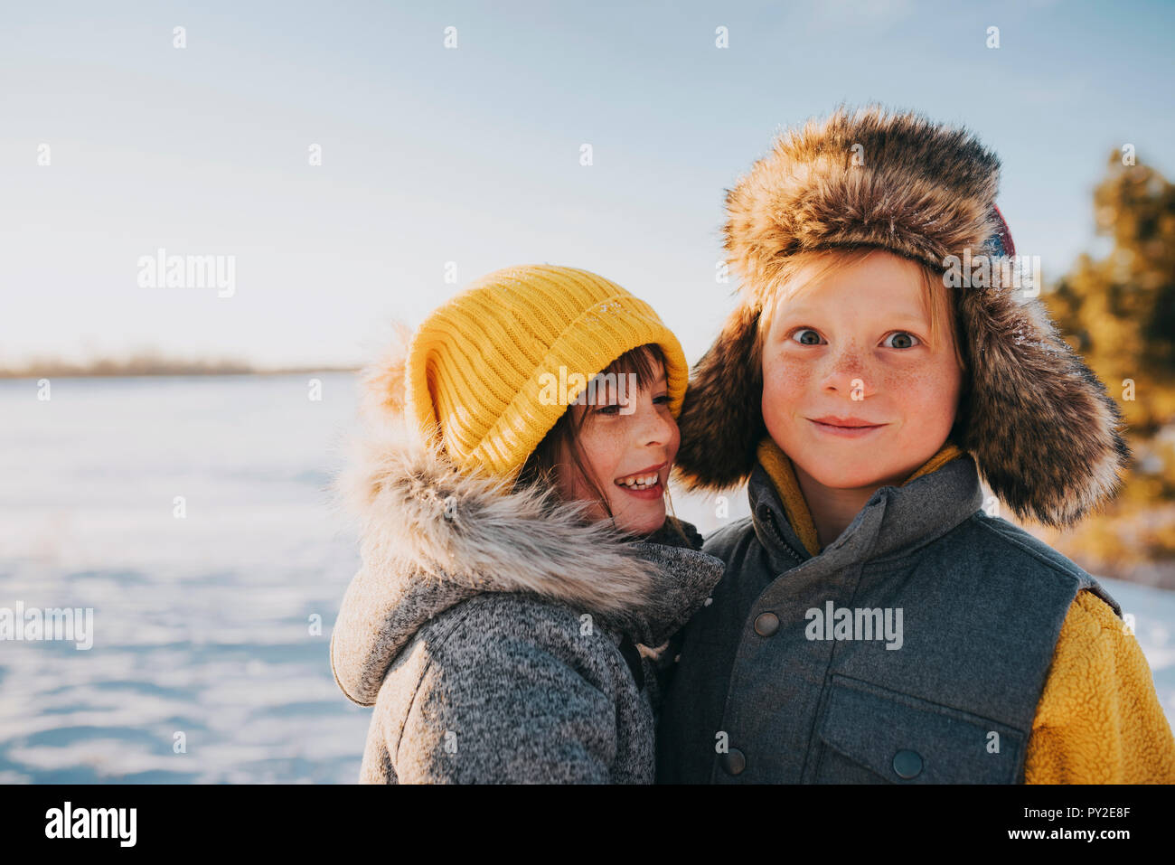 Portrait of a boy and girl standing by a lake, United States Stock ...