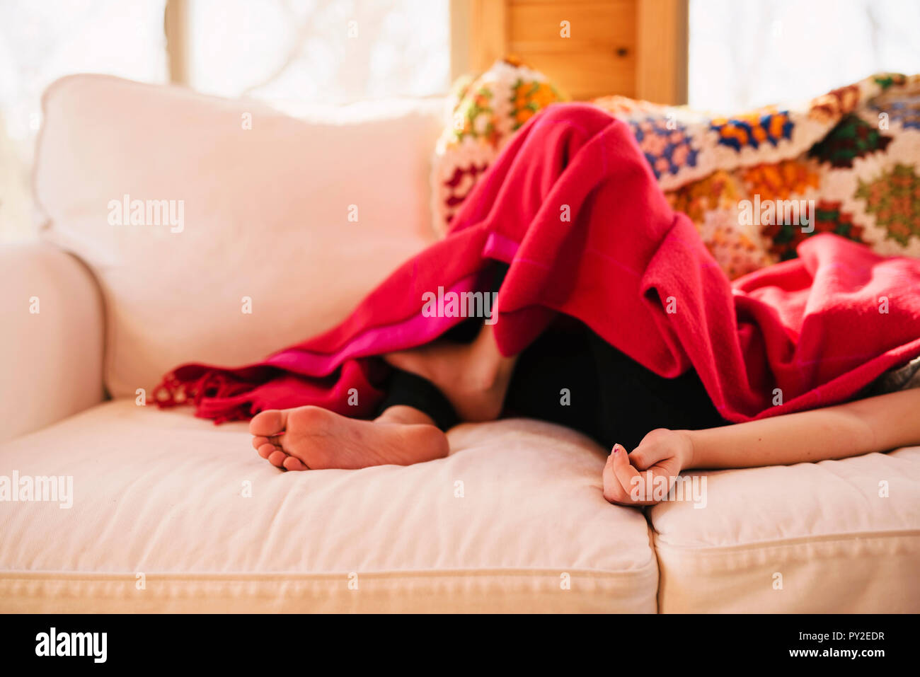 Barefoot girl lying on couch hires stock photography and images Alamy