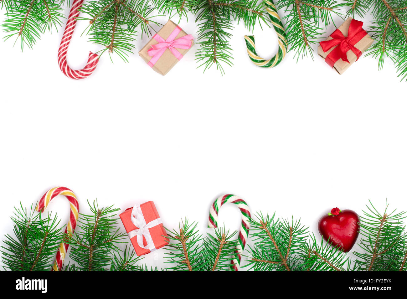 Christmas Frame of Fir tree branch with candy canes and boxes isolated ...