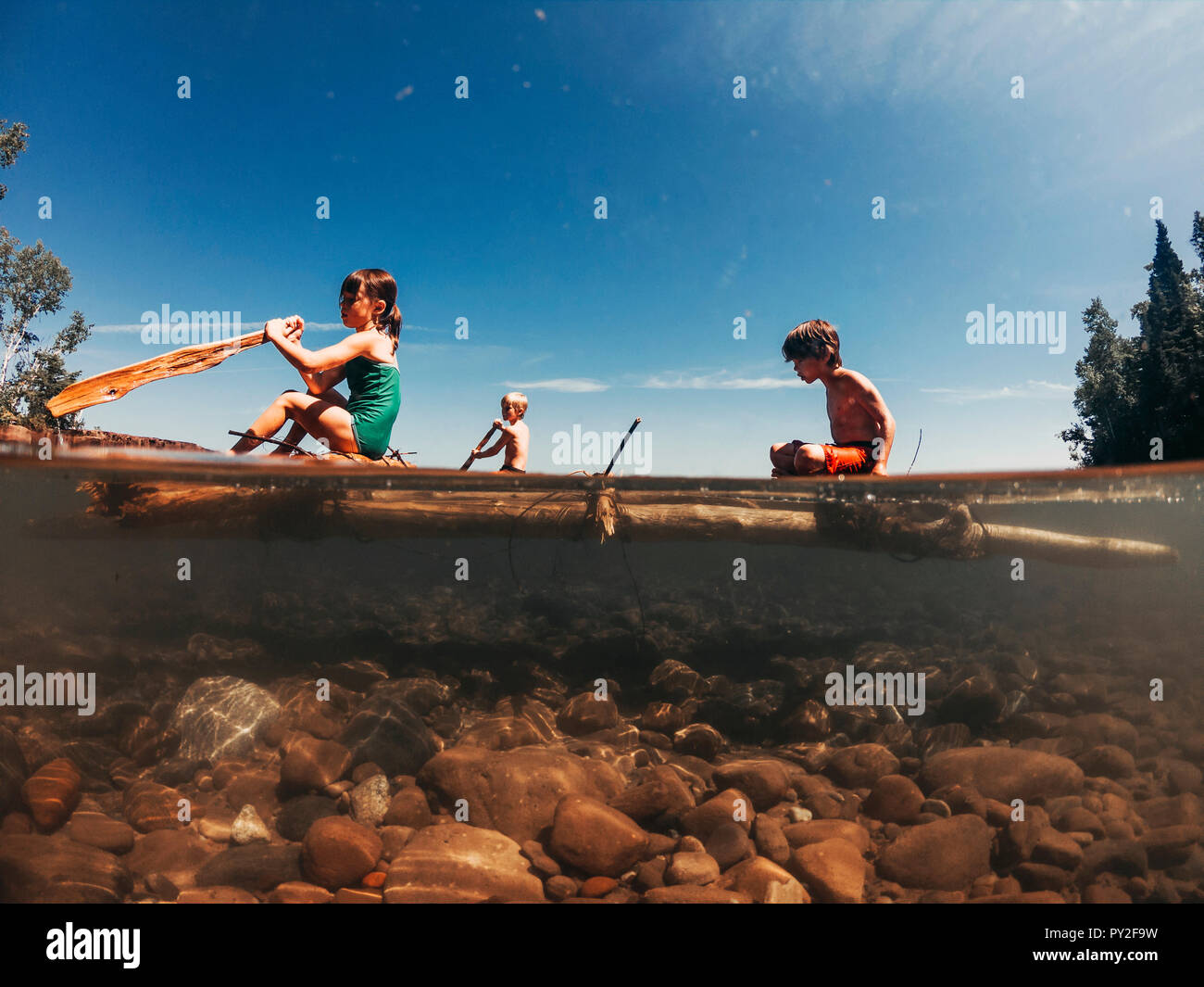 Saling Raft Three children sailing on a lake on a wooden raft, Lake Superior ...