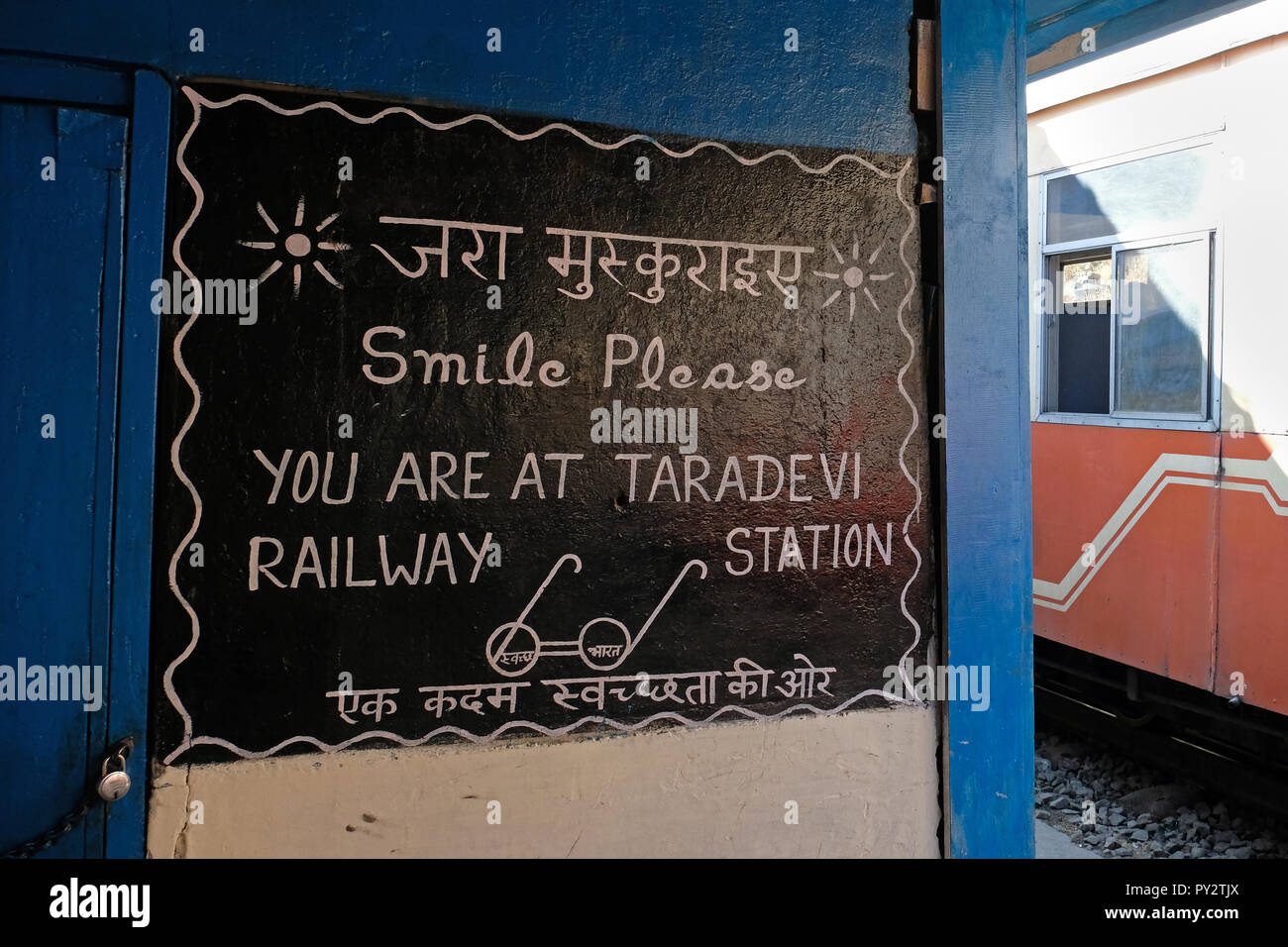 Sign saying 'smile please you are at Taradevi station' on the Shimla toy train line Stock Photo
