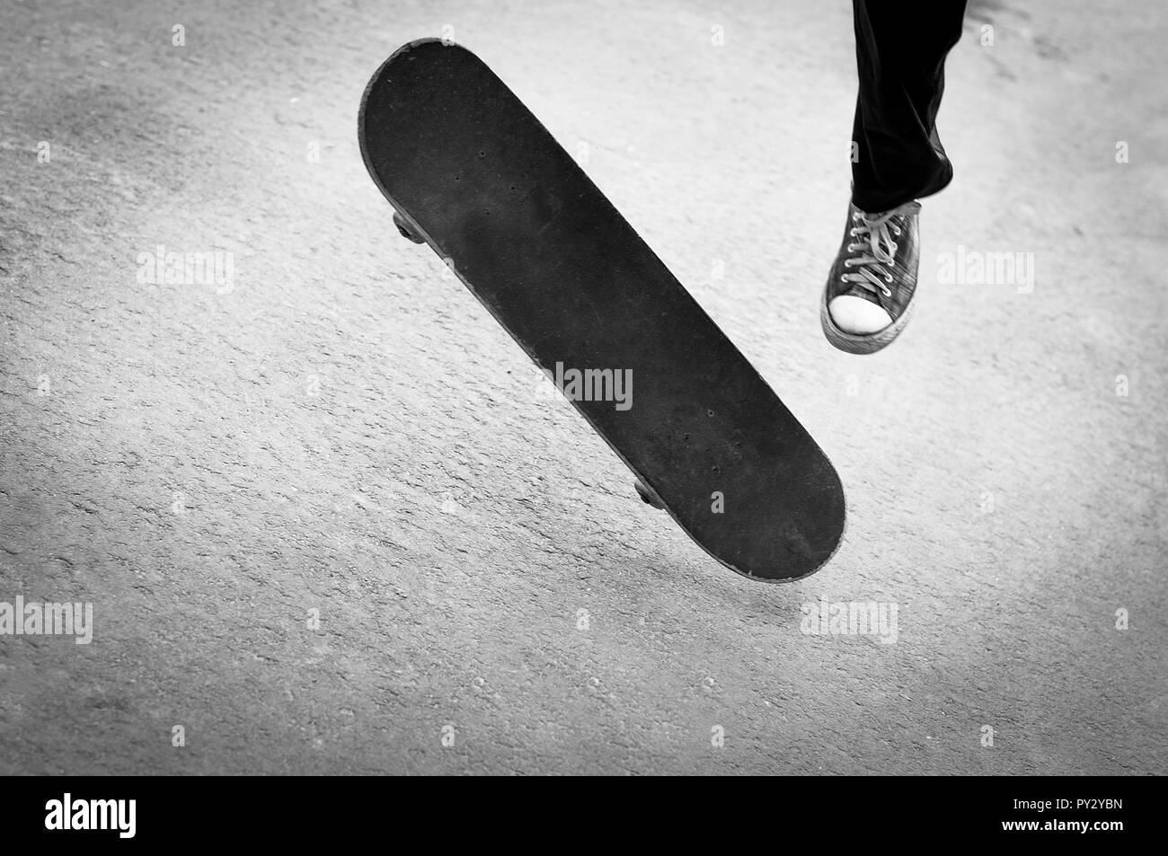 The moment of performing a skateboarding trick. Stock Photo
