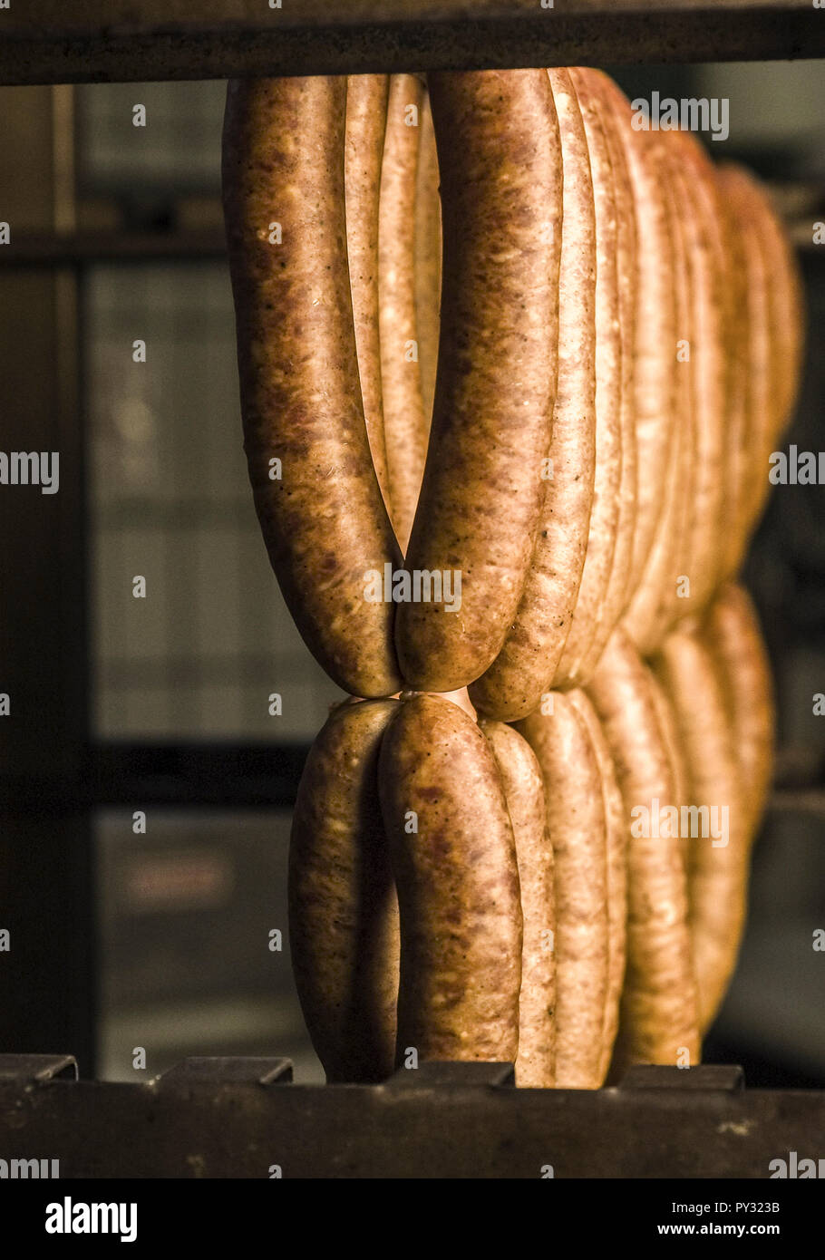 Wuerstchen haengen im Raeucherofen Stock Photo