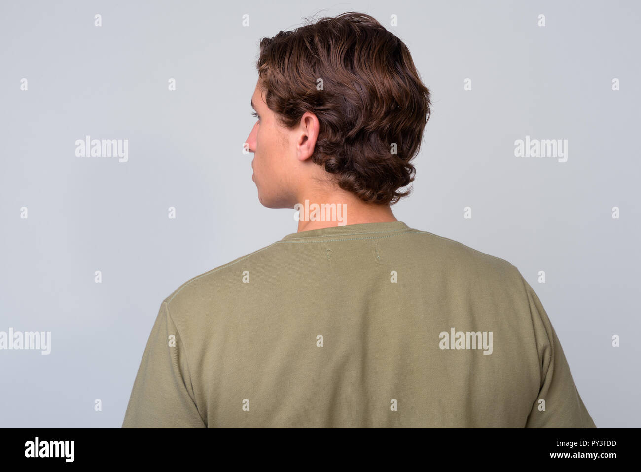 Young Handsome Man With Wavy Hair Against White Background Stock