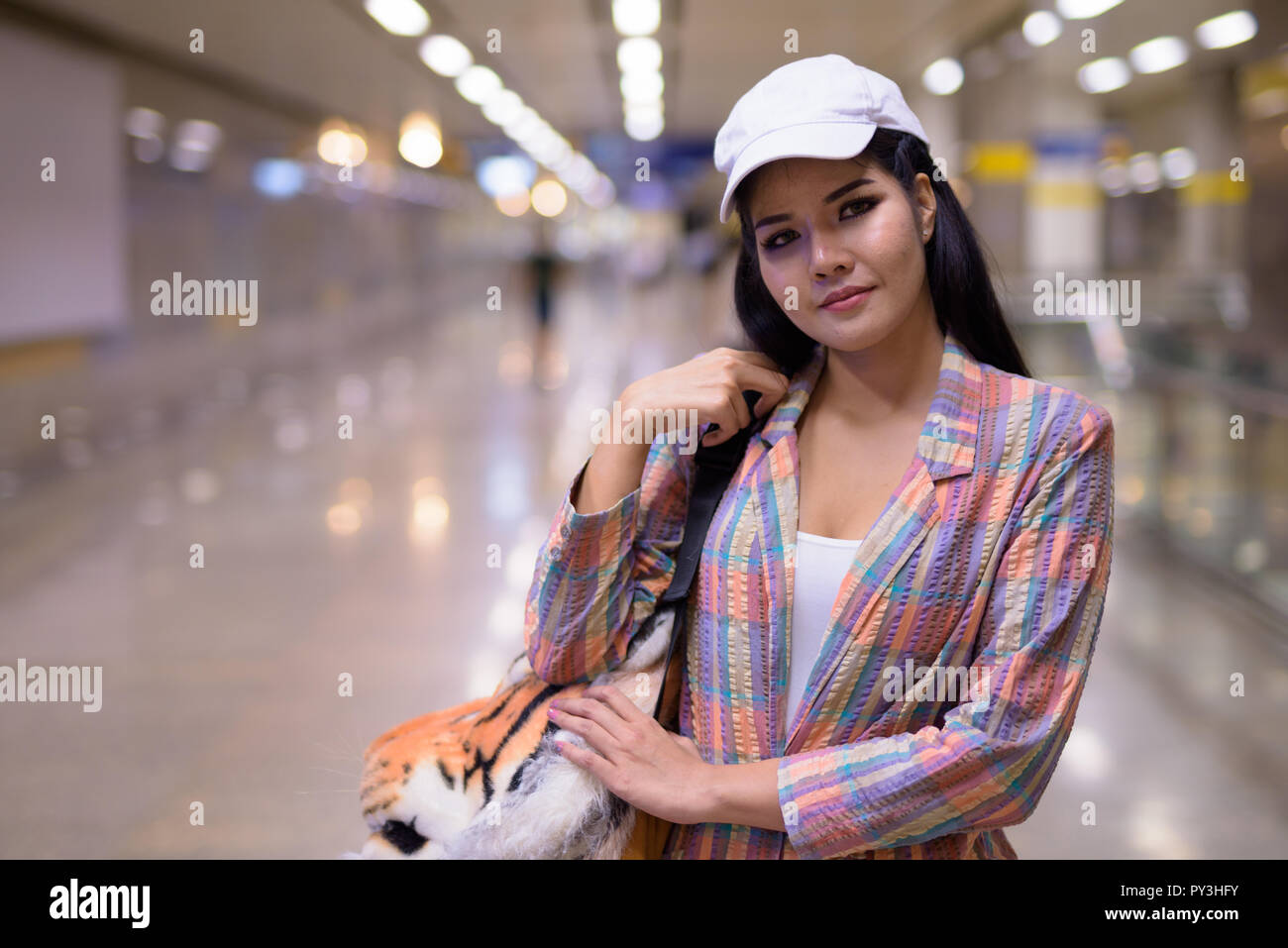Portrait of Asian tourist woman in train station Stock Photo