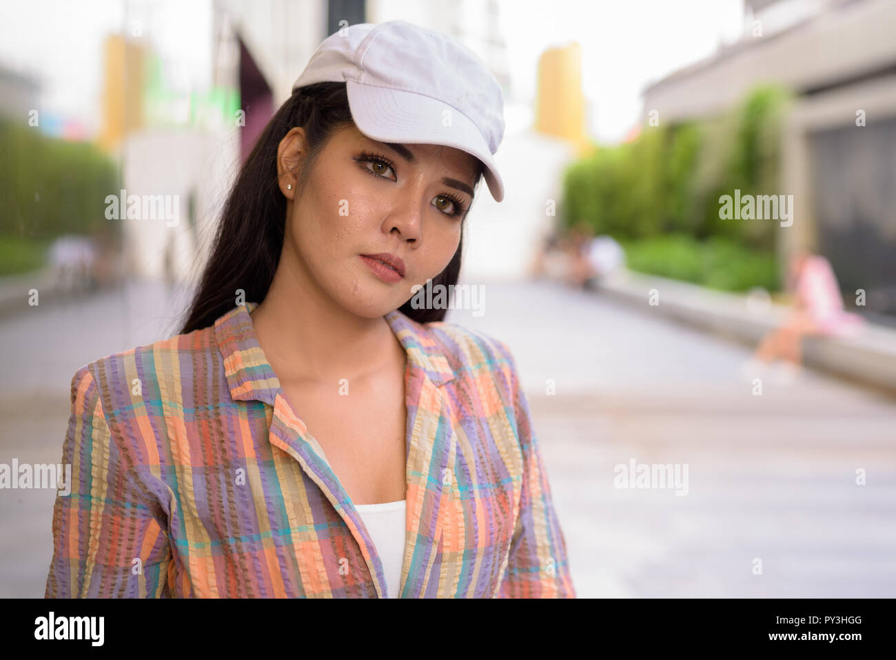 Young beautiful Asian tourist woman thinking outdoors Stock Photo