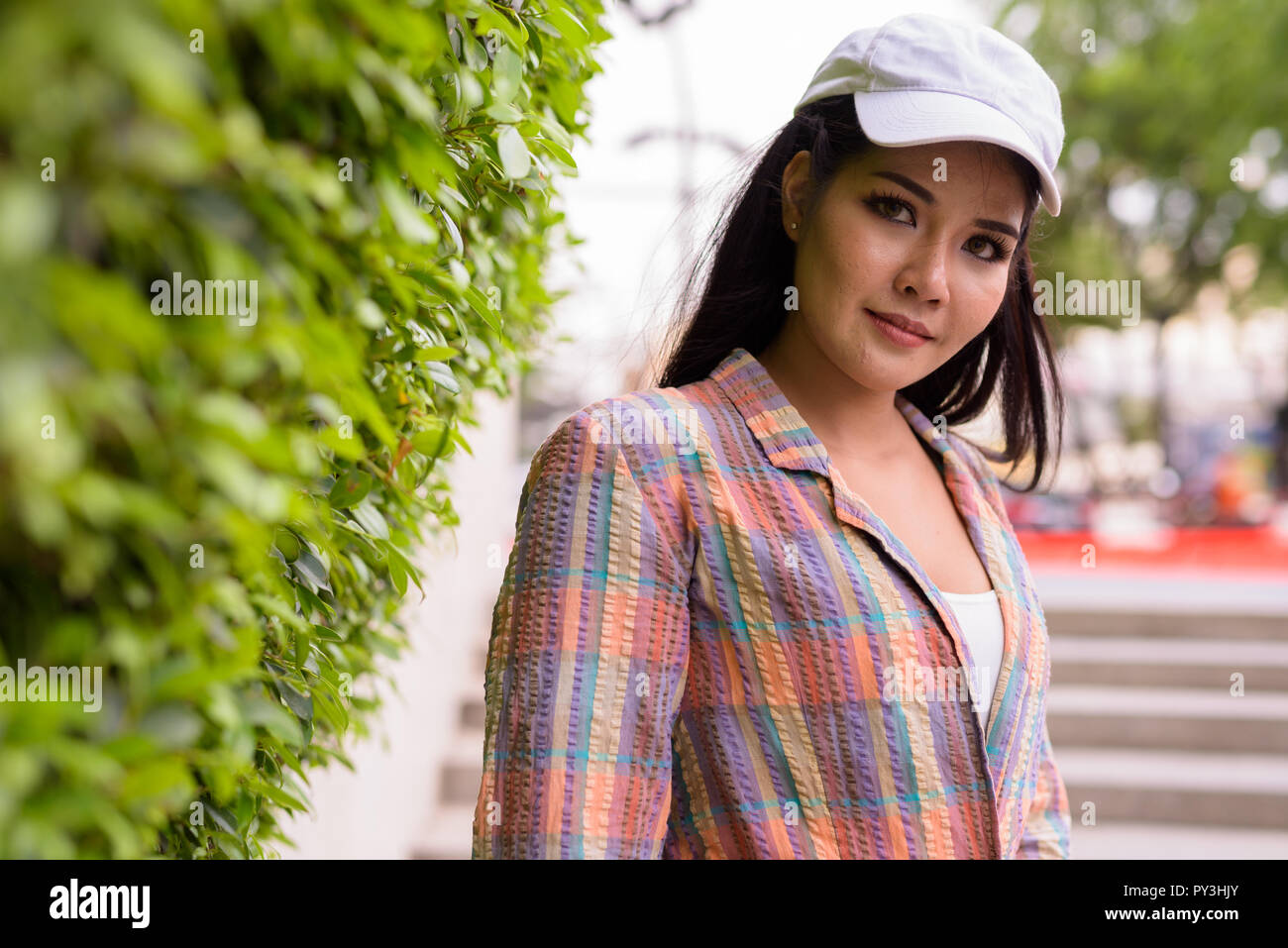 Young beautiful Asian tourist woman exploring the city Stock Photo