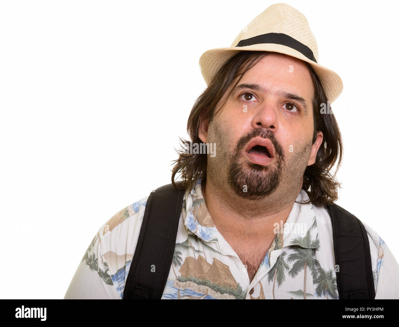 Fat bearded Caucasian tourist man looking exhausted Stock Photo