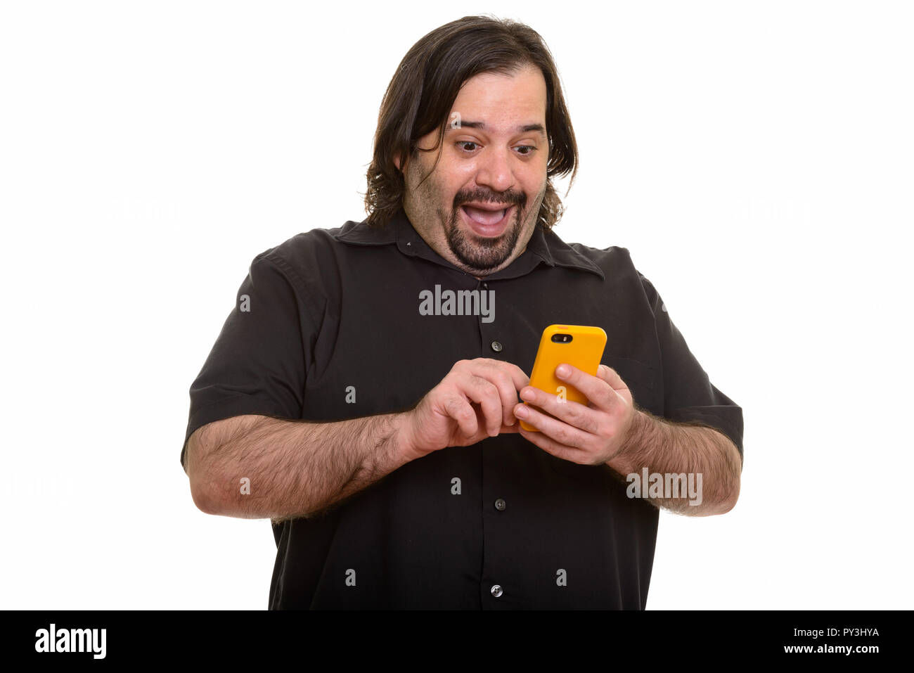 Happy fat Caucasian man laughing while using mobile phone Stock Photo