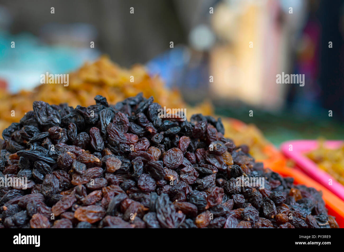 Close up of black dried grapes for sale in local market, Pune Maharashtra. Stock Photo