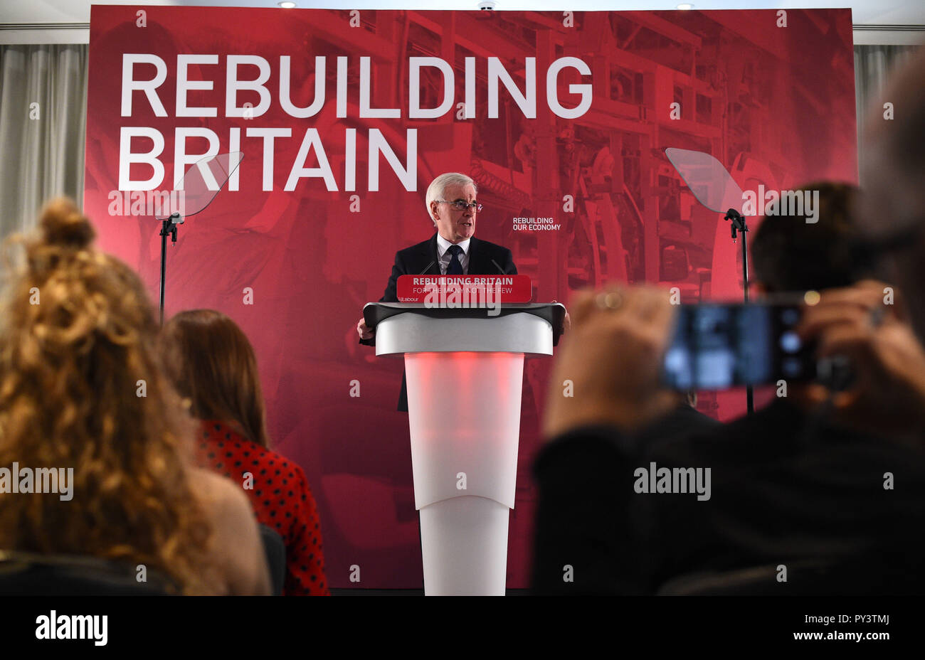 Shadow chancellor John McDonnell makes a speech at Savoy Place in London where he called on Chancellor Philip Hammond to admit the 'scale of the hardship' which eight years of Conservative austerity have inflicted on voters when he delivers his Budget on Monday. Stock Photo