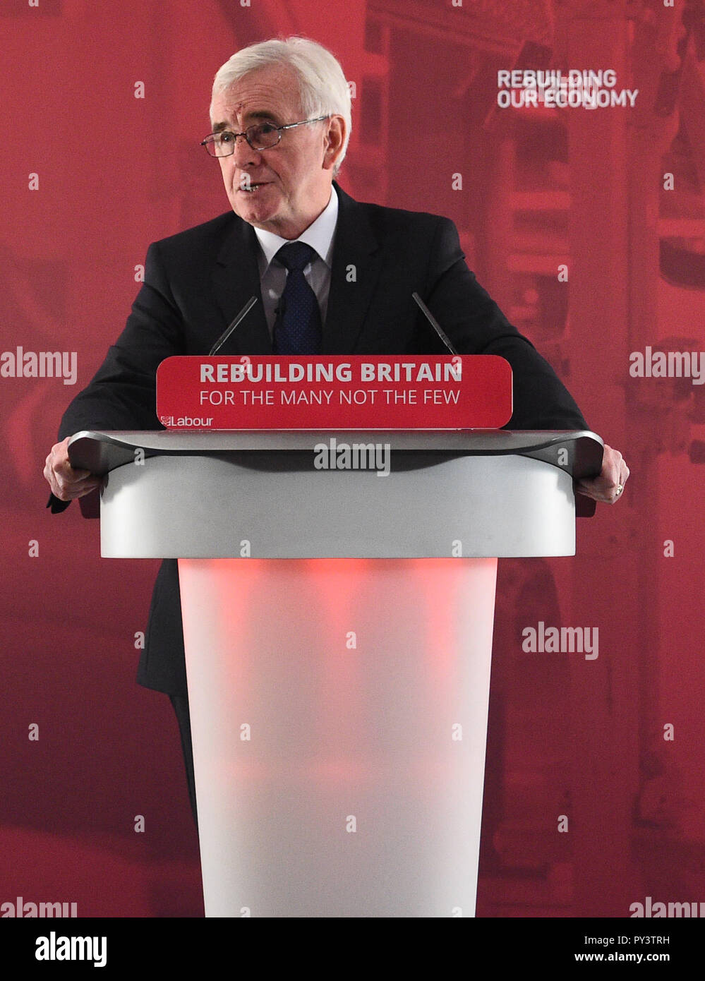 Shadow chancellor John McDonnell makes a speech at Savoy Place in London where he called on Chancellor Philip Hammond to admit the 'scale of the hardship' which eight years of Conservative austerity have inflicted on voters when he delivers his Budget on Monday. Stock Photo