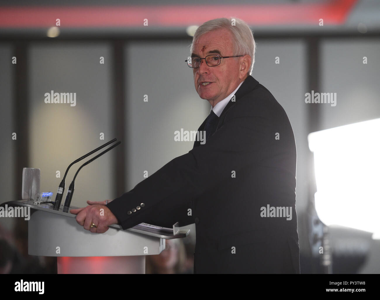 Shadow chancellor John McDonnell makes a speech at Savoy Place in London where he called on Chancellor Philip Hammond to admit the 'scale of the hardship' which eight years of Conservative austerity have inflicted on voters when he delivers his Budget on Monday. Stock Photo