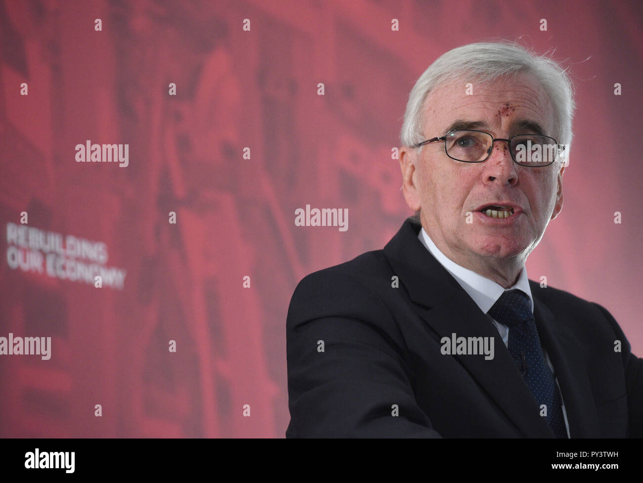 Shadow chancellor John McDonnell makes a speech at Savoy Place in London where he called on Chancellor Philip Hammond to admit the "scale of the hardship" which eight years of Conservative austerity have inflicted on voters when he delivers his Budget on Monday. Stock Photo
