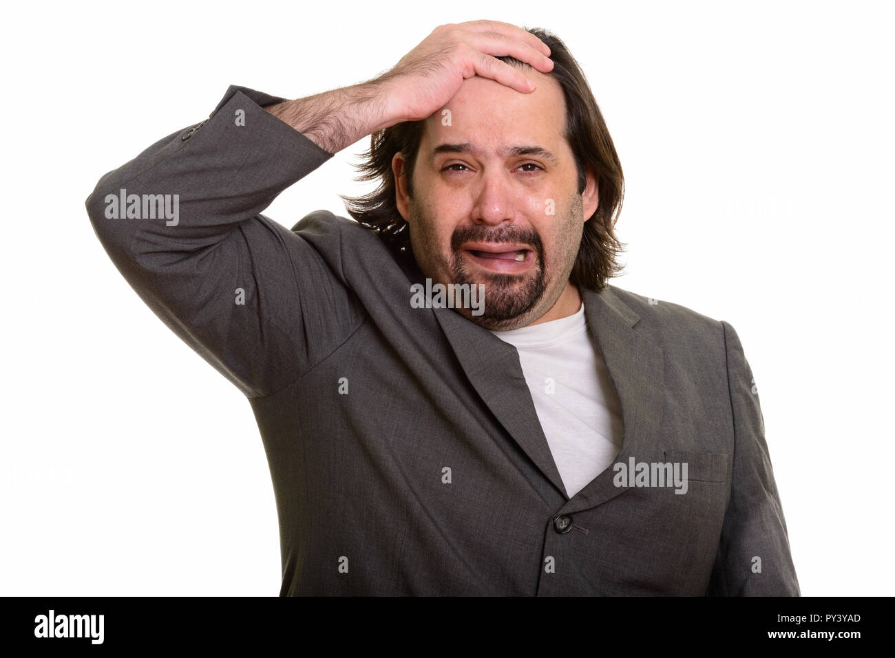 Fat Caucasian businessman crying and looking sad Stock Photo