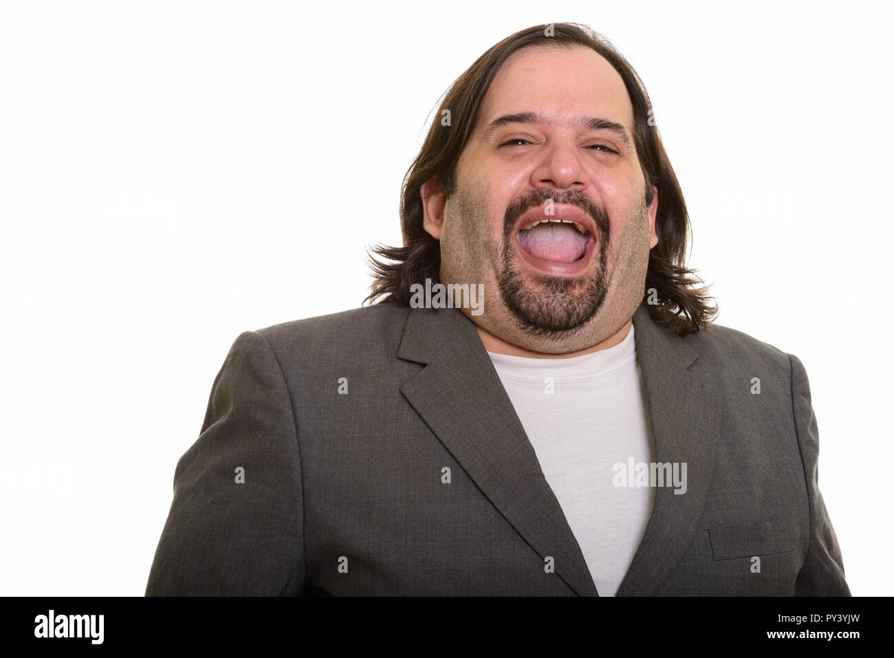 Happy fat Caucasian businessman smiling and laughing Stock Photo