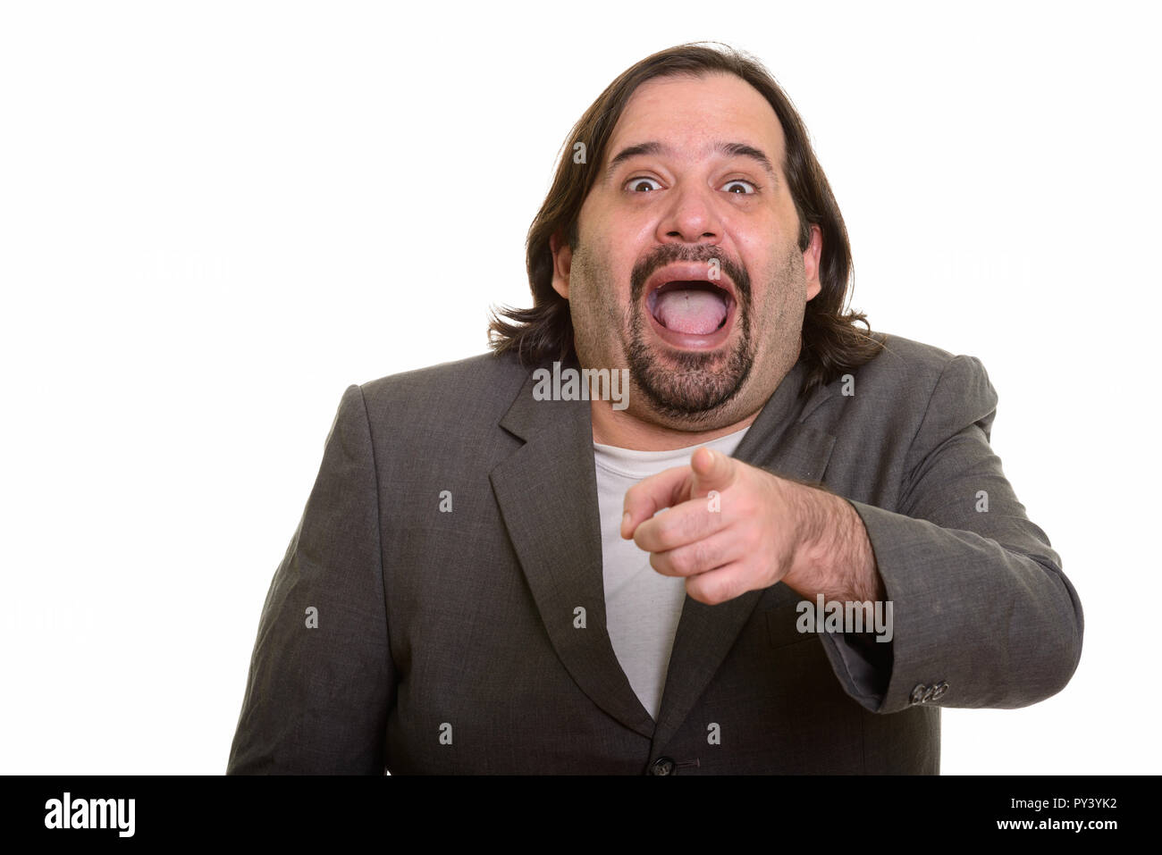 Happy fat Caucasian businessman smiling while laughing and point Stock Photo