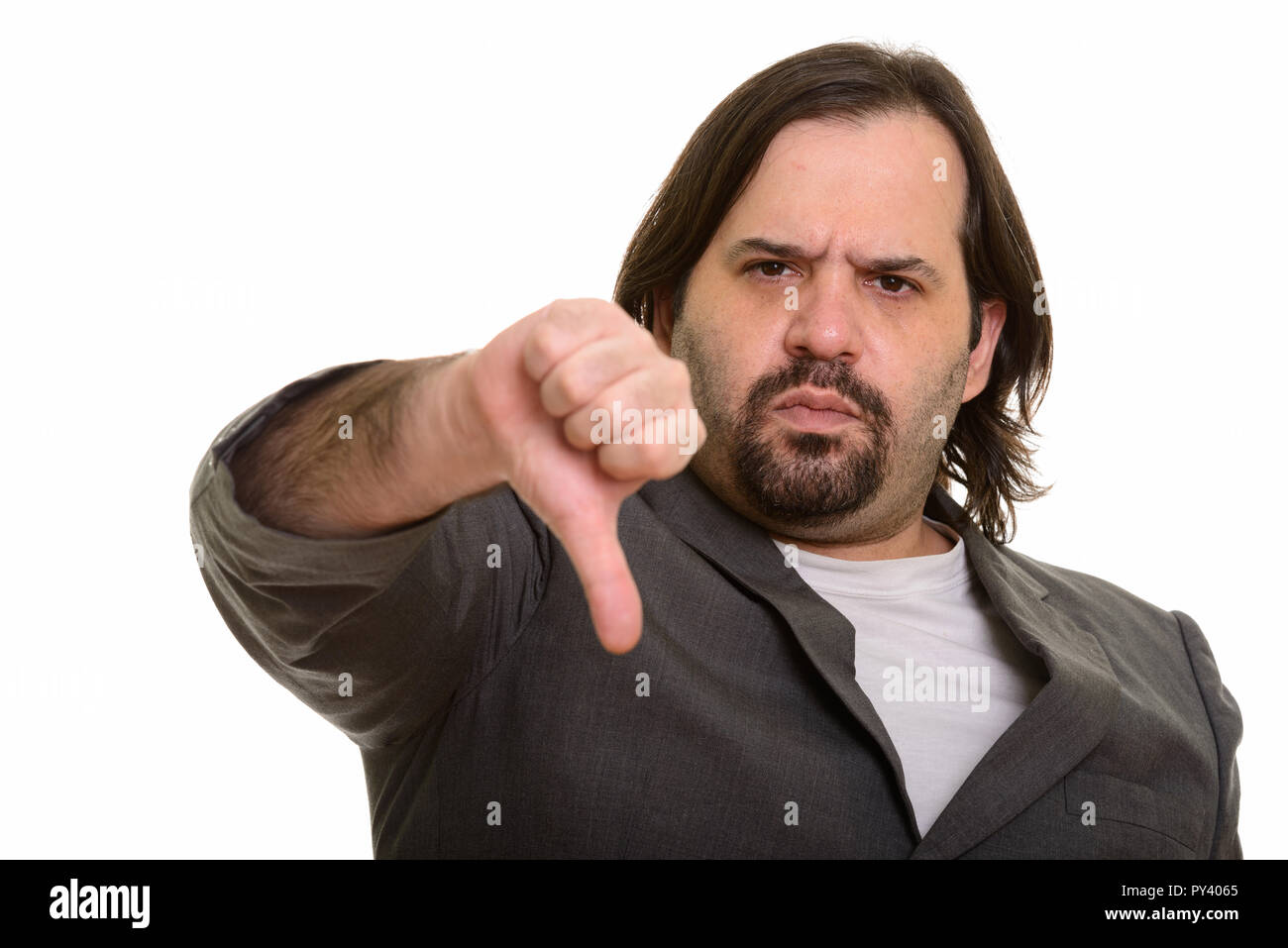 Serious fat Caucasian businessman giving thumb down Stock Photo