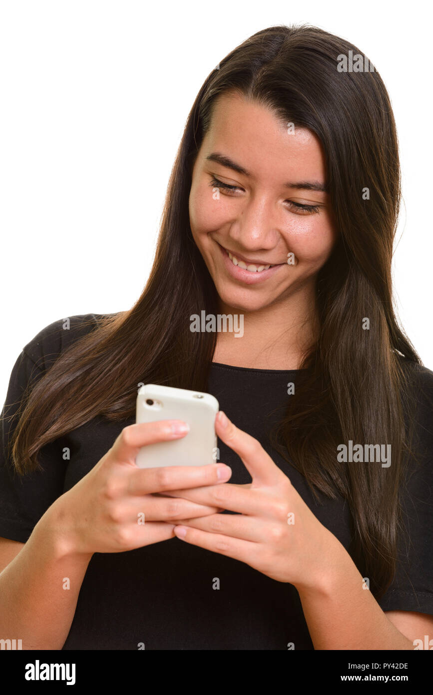 Young happy Caucasian woman smiling and using mobile phone Stock Photo