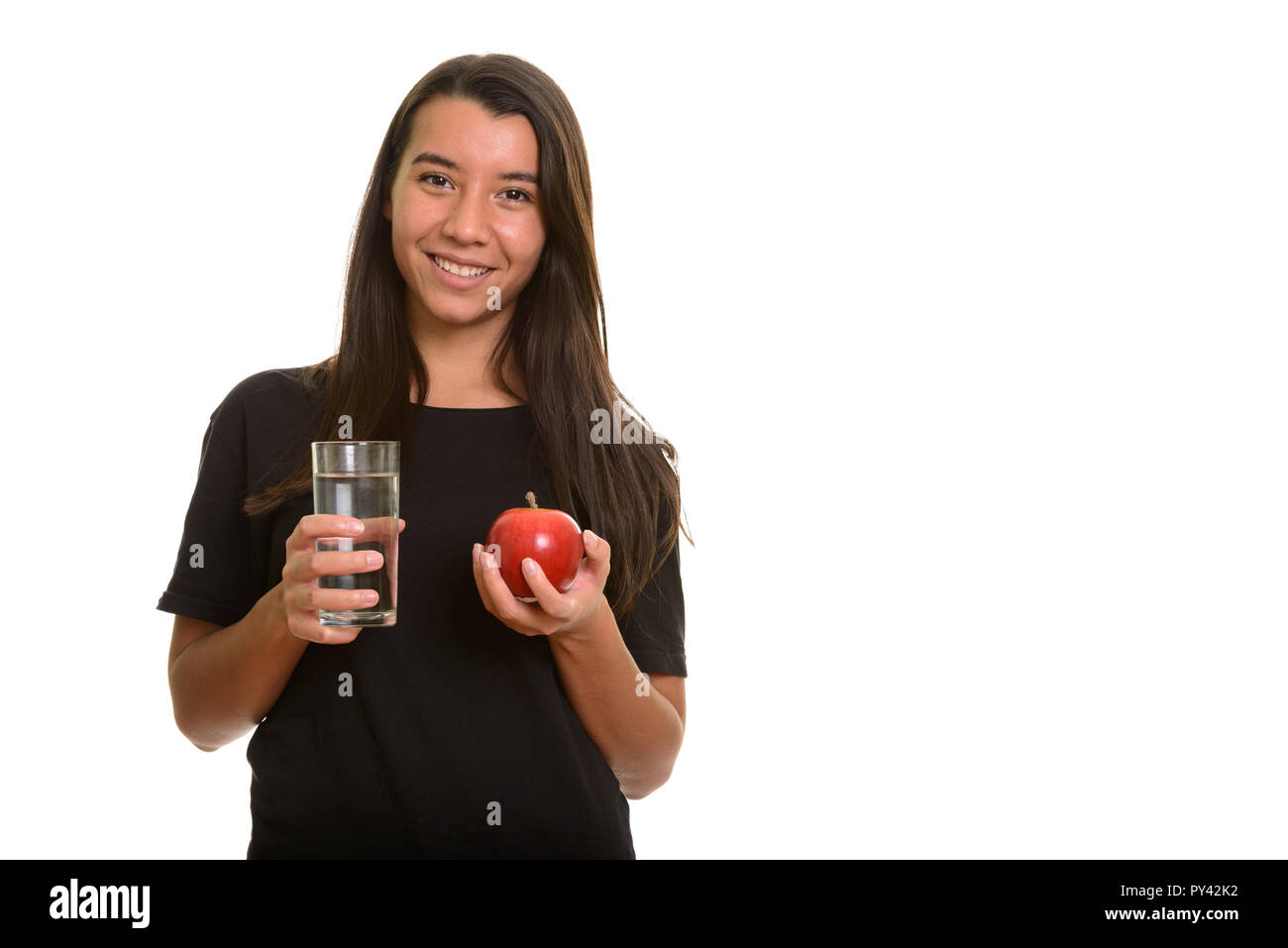 Young happy Caucasian woman smiling while holding red apple and  Stock Photo