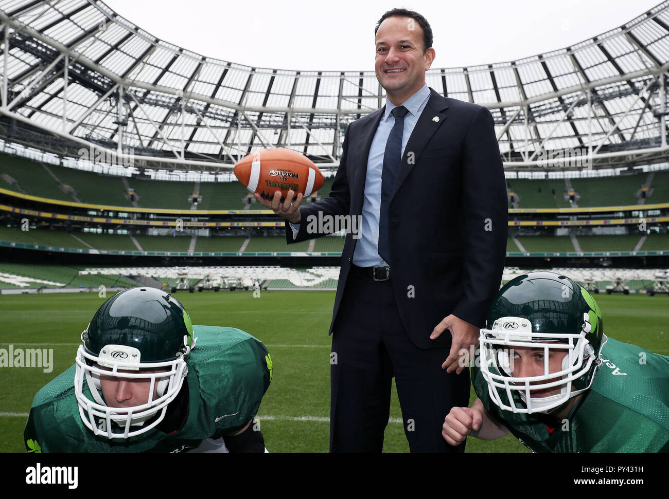 An Taoiseach Leo Varadkar with players from Cork Admirals American football team Cillian McGillycuddy (left) and Aidan Waters, at the Aviva stadium, Dublin, for the announcement of plans for a five-game American college football series. Stock Photo