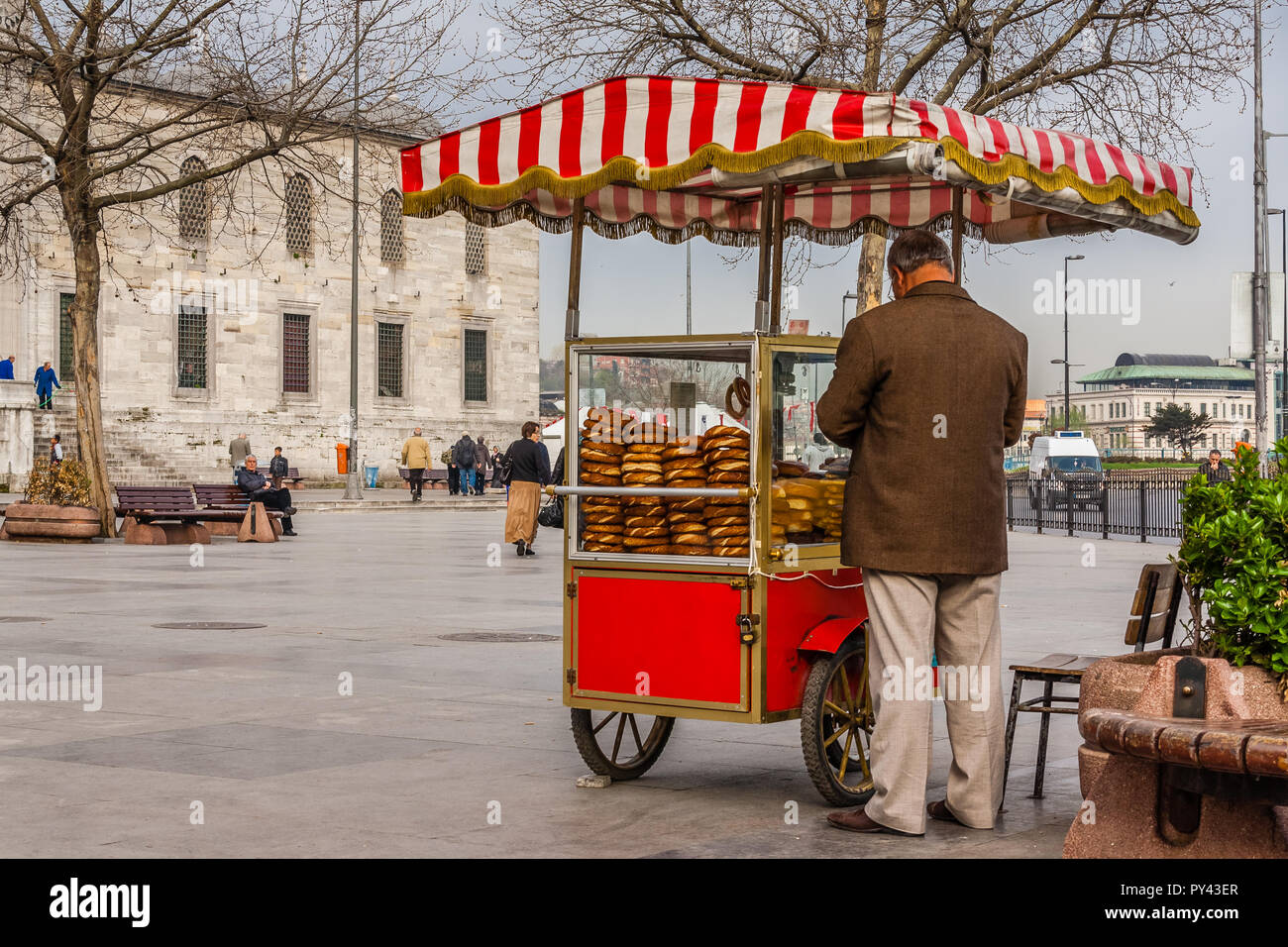 Istanbul, Turkey,April 5. 2012: Man selling simit (Turkish bagels) from a cart. Stock Photo