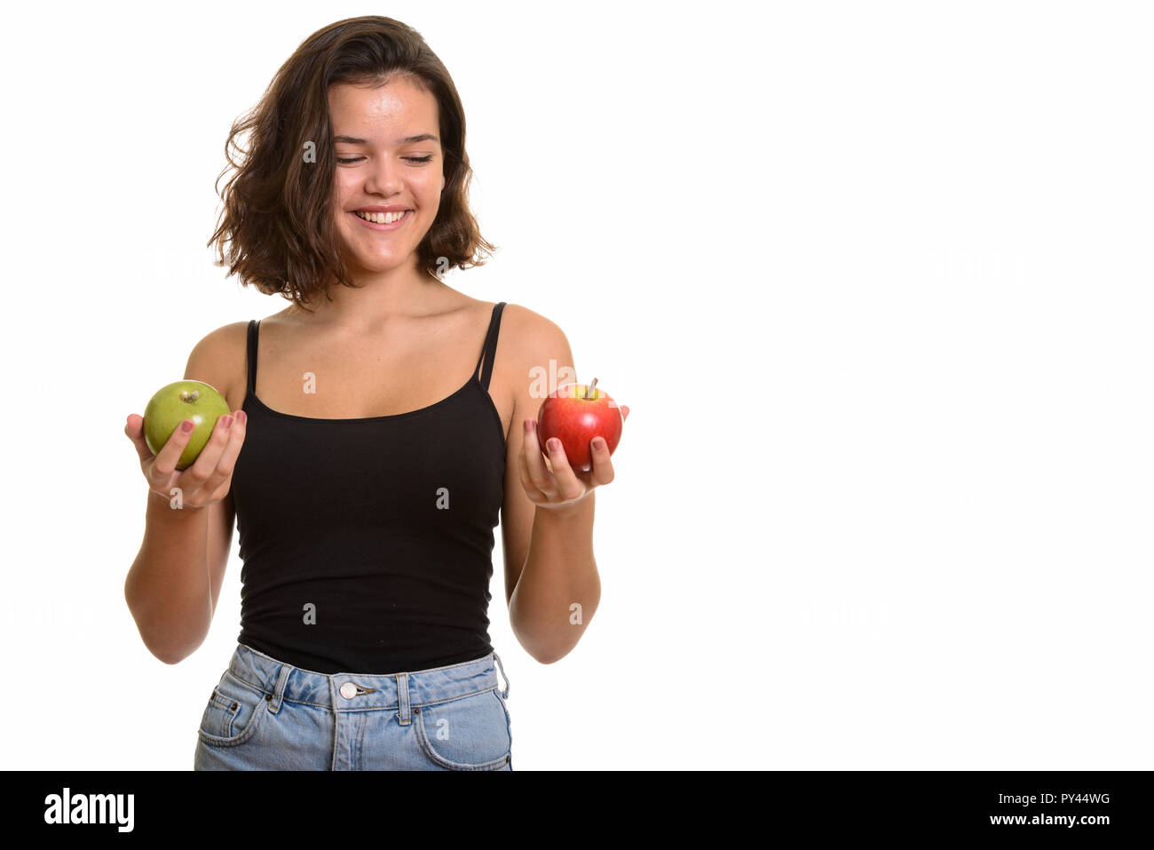 Young happy Caucasian teenage girl smiling while choosing betwee Stock Photo